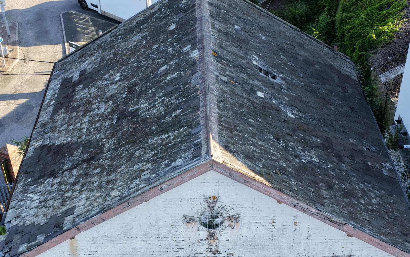 Aerial view of the hipped slate roof and painted brick gable of The White House at Red Cow Village, Exeter St Davids